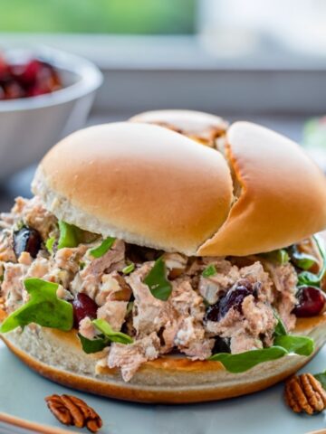 Turkey salad sandwich with mayo, pecans and dried cherries on a fresh bun.