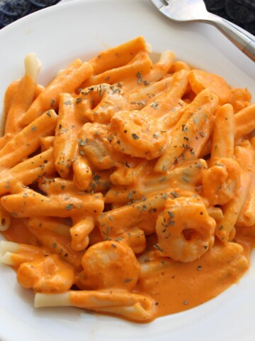 Pasta smothered in creamy red pepper sauce dotted with tiny shrimp.