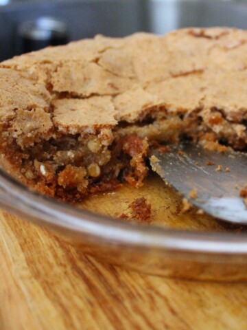 A cut Ritz Cracker Pie in a clear pie plate.
