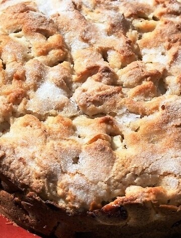Close up of apple cake sprinkled with sugar.