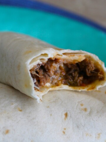 Rolled up flour tortilla stuffed with beef carnitas and cheese.