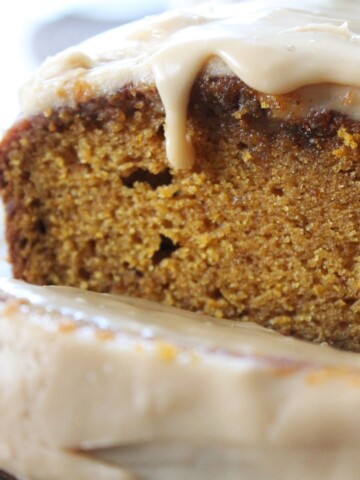 Sliced pumpkin bread with thick caramel icing.