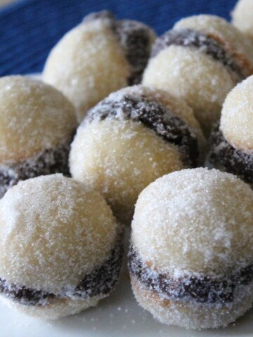 Mini, round vanilla sandwich cookies with a chocolate ganache filling.