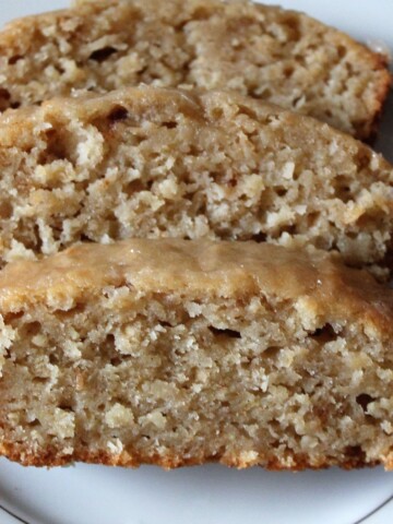 Three slices of applesauce cake on a white plate.