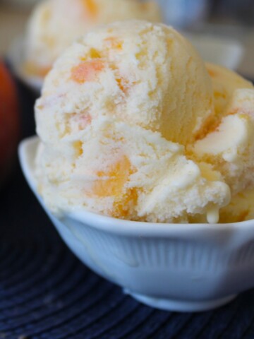Small bowl of fresh peach ice cream.