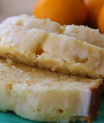 Slices of lemon cake with glaze on a blue plate.
