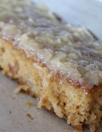 Side shot of fruit cocktail cake with a coconut icing.