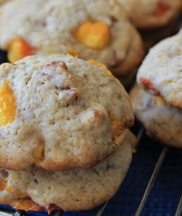 Stacks of peach cookies on a cooling rack.