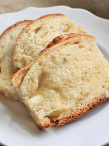 Slices of warm cheesy bread with melted butter.