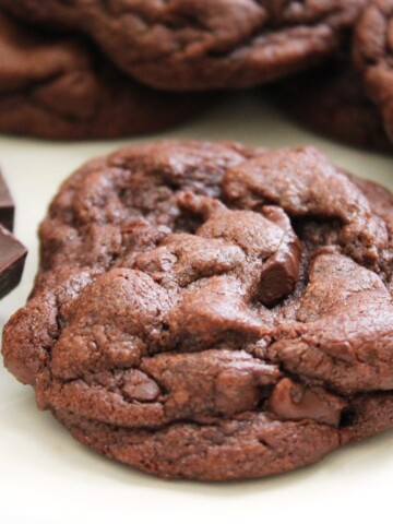 A large, soft, chewy chocolate cookie with chunks of chocolate.