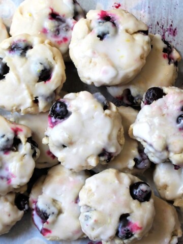 Overhead view of soft cookies stuffed with blueberries.