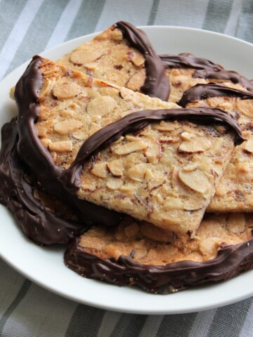 Crispy toffee cookies, filled with almonds and dipped in chocolate.