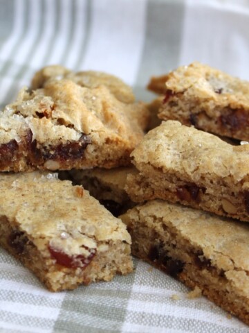 Date Nut bars stacked on a green and white cloth.