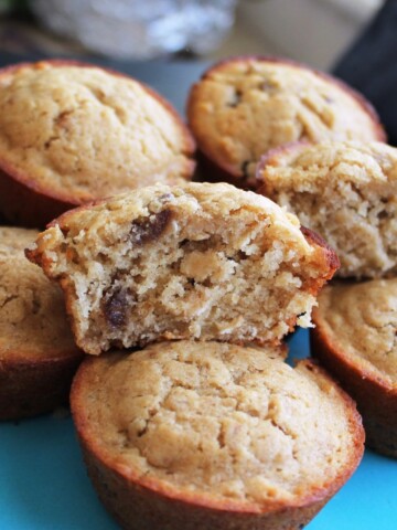 Stacks of Oatmeal Muffins, one is split in half.