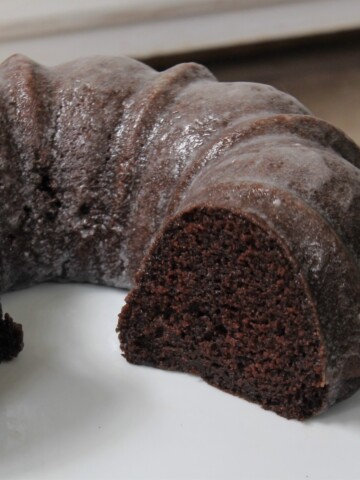 Chocolate bundt cake, sliced, and with a light glaze.