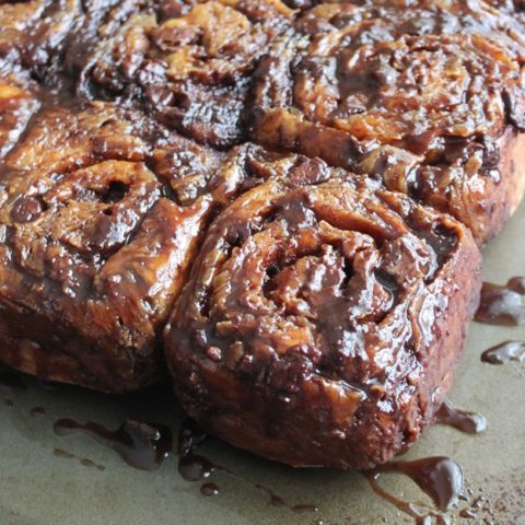 Side view of sticky buns on a pan.