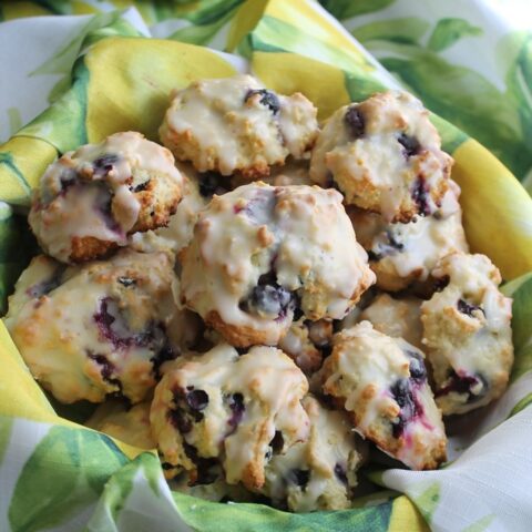 Blueberry biscuits in a basket with yellow cloth