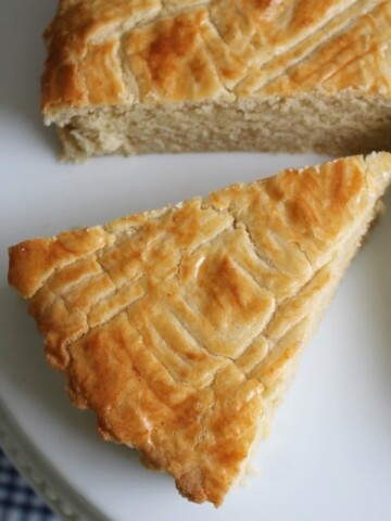 Close up of a slice of butter cake on a white plate.