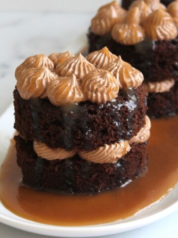 Mini Chocolate Espresso with Burnt Caramel, close up sitting on a puddle of caramel on a white plate.