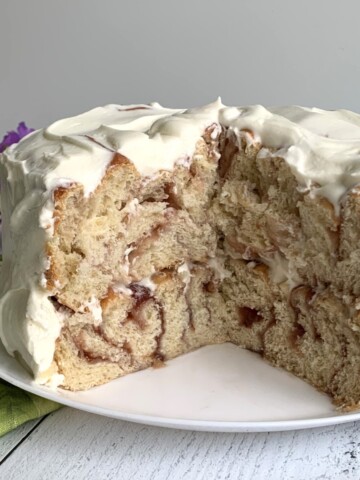 Cut Strawberry Cinnamon Roll Cake on a white plate.