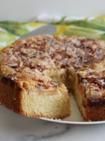 Apple Cinnamon Everyday Cake on a white plate on a marble placemat.
