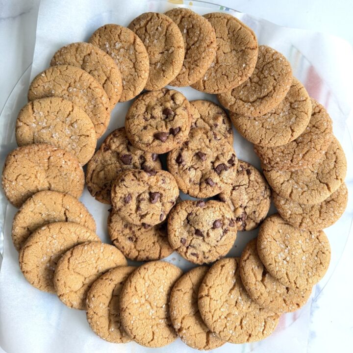 Overhead view of a circle of Biscoff sugar cookies as well as a pile with chocolate chips in them.